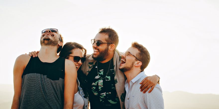 Vier vrienden lachen met elkaar